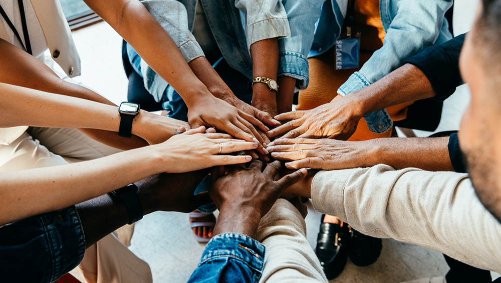 hands held together in the center as a team